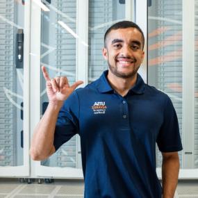 Latino student smiling doing birdsup